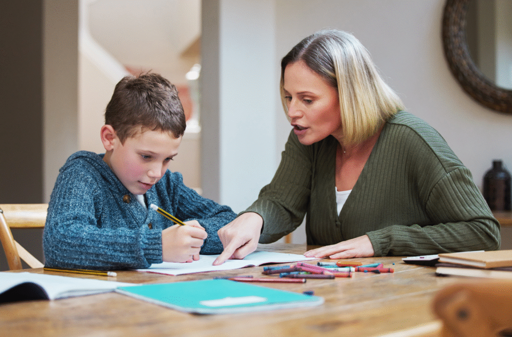 A mother and her son review workbooks for homeschooling