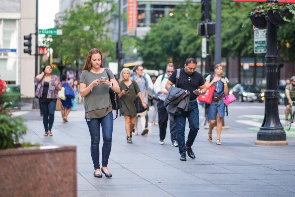 people search on their cell phones while walking